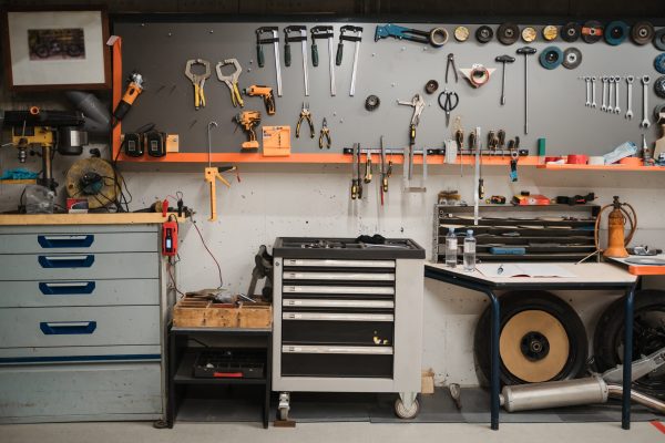 Workshop scene. Tools hanging on the wall in the workshop, garage vintage style
